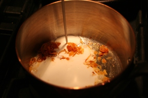 Adding coconut milk to the pan
